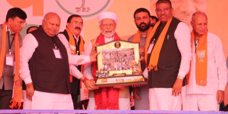 Upcoming Dhaman Gujarati movie's producer Bhupat Bodar presents memento to PM Modi behalf of his Dhaman team 